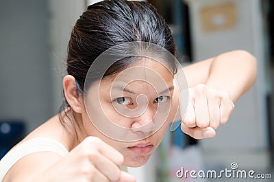 Asian woman ready to fight guarding with empty hand Stock Photo