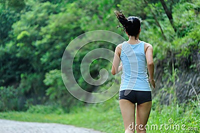 Asian woman runner running outdoor Stock Photo