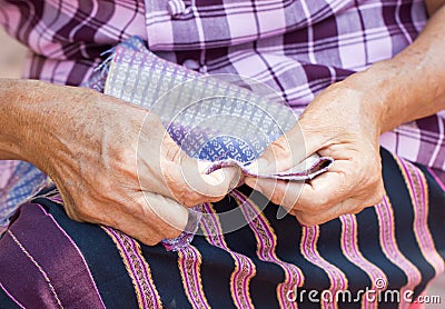 Asian Woman's Hand Sewing. Stock Photo