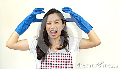 Asian woman screaming and stress from doing housework chores Stock Photo