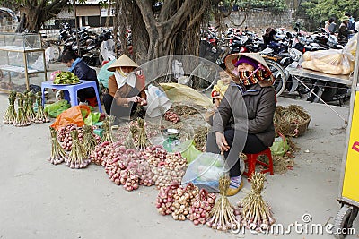 Asian woman selling onions in the market Editorial Stock Photo