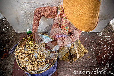 Asian woman selling peanuts on street Editorial Stock Photo