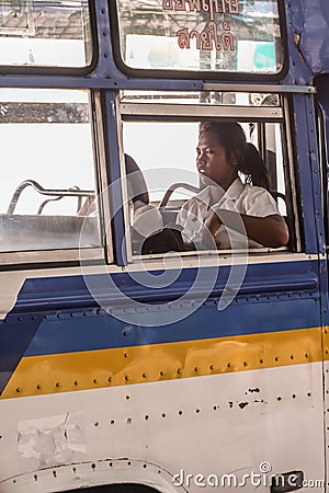 Asian woman sitting in the bus, side view. Locals of Bangkok. Local people of Asia. Editorial Stock Photo