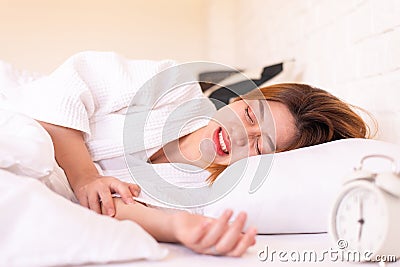 Asian woman sleeping on the bed and grinding teeth,Female bruxism Stock Photo