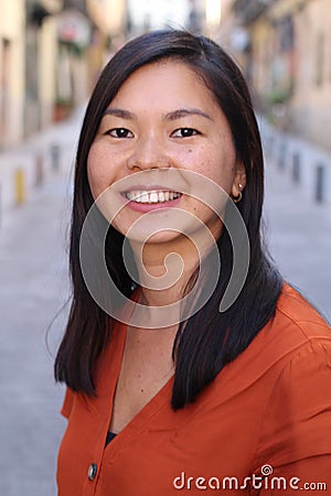 Asian woman smiling outdoors headshot Stock Photo