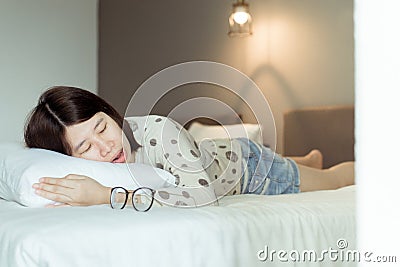 Asian woman snoring because due to tired of work,Female snor while sleeping open your mouth on bed Stock Photo