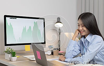Asian woman is studying online via the internet with a cheerful smile, stay home Stock Photo