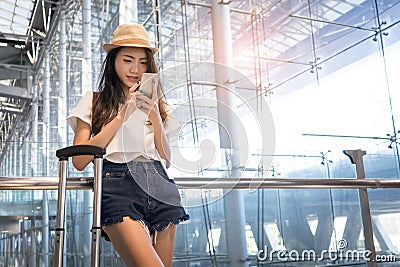 Asian woman teenager using smartphone at airport Stock Photo