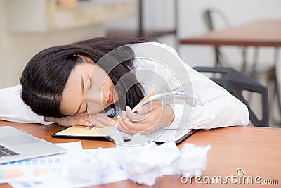 Asian woman with tired overworked and sleep, girl have resting while work writing note Stock Photo