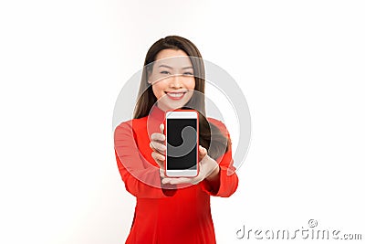 Asian woman in traditional vietnamese dress, presenting mobile screen or application for digital business and technology concept Stock Photo