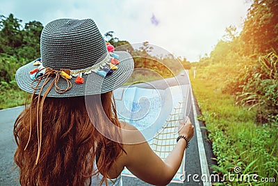 Asian women travel relax in the holiday. Take a look at the map on a rural road in the middle of nature. Thailand Stock Photo