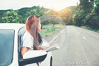 Asian woman traveler with car on Beautiful road Stock Photo