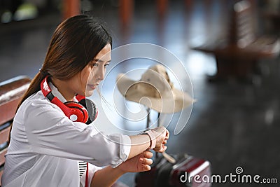 Woman traveler checking time on her smart watch. Stock Photo
