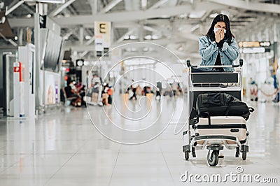 Asian woman traveler wearing mask sneezing Stock Photo