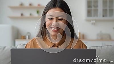 Asian woman typing laptop in kitchen korean vietnamese businesswoman working from home smiling millennial ethnic chinese Stock Photo
