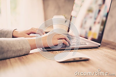 Asian woman using computer laptop for working on wooden table Stock Photo