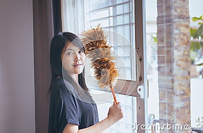 Asian woman using a dust brush,Hands of housemaid,dusting Stock Photo