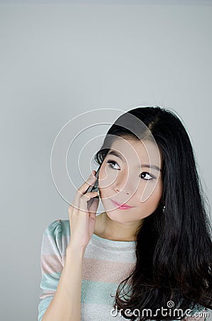 Asian woman using telephone Stock Photo