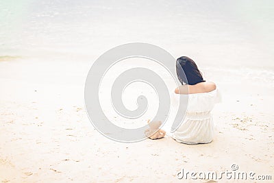 Asian woman waiting for love or somethings that make her happy. Lonely and Beauty concept. Back view scene of girl. Ocean and sea Stock Photo