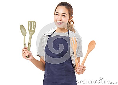 Asian Woman Wearing Apron And Showing Cooking Tools. Stock Photo