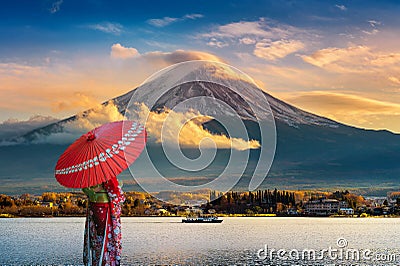 Asian woman wearing japanese traditional kimono at Fuji mountain. Sunset at Kawaguchiko lake in Japan Stock Photo