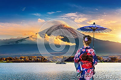 Asian woman wearing japanese traditional kimono at Fuji mountain. Sunset at Kawaguchiko lake in Japan Stock Photo