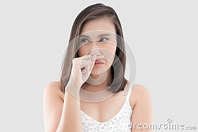 Asian woman in white dress catch her nose because of a bad smell Stock Photo