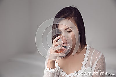 Woman drinking water before bedtime Stock Photo