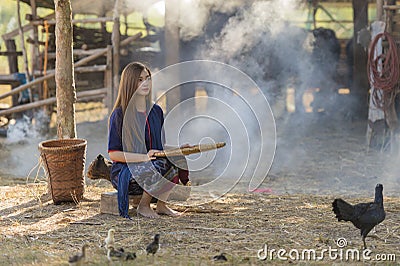 Asian woman worker winnowing rice separate. Stock Photo