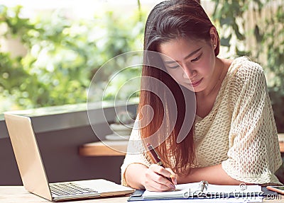 Asian woman is working at home Stock Photo