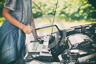 Asian women engineer holding a wrench in hand, prepared for the Stock Photo