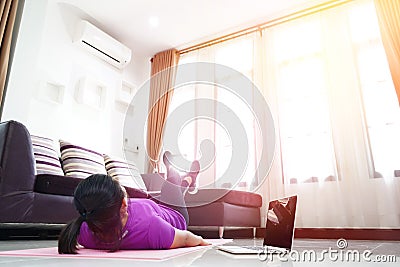 Asian women exercise doing legs scissors abdominal abs workout at home Stock Photo