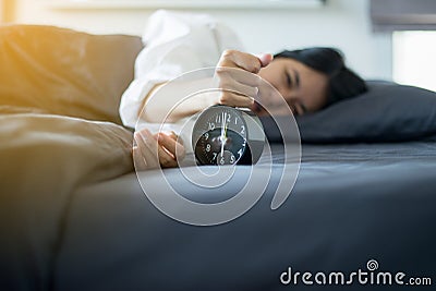 Asian women hates getting stressed waking up early 6 o`clock in the morning,Alarm clock Stock Photo