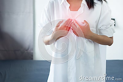 Asian woman having or symptomatic reflux acids,Gastroesophageal reflux disease,Because the esophageal sphincter that separates the Stock Photo