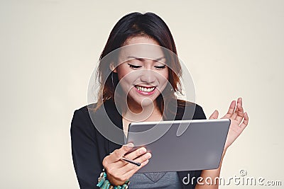 Asian women look at his iPad with a happy mood Stock Photo