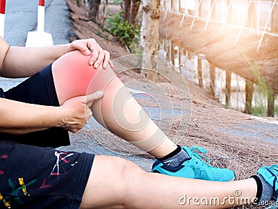 Asian women sit and have knee pain, calf pain, and inflamed leg muscles from jogging Stock Photo