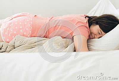 Asian women sleeping on the bed and grinding teeth,Female tiredness and stress Stock Photo
