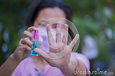 Asian women spry alcohol to clean her hand Stock Photo