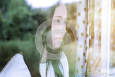 Asian women standing by the mirror reflecting the green forest Stock Photo