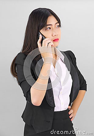 Asian women in suit standing posing using phone Stock Photo