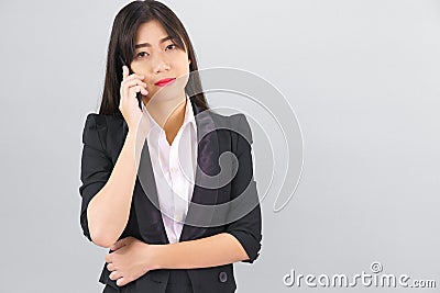 Asian women in suit standing posing using phone Stock Photo