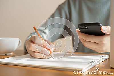 Asian women take notes with a pencil in the office, business woman working on table Stock Photo