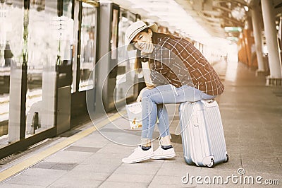 Asian women travelers, smile happily Hold the map in hand, Sit o Stock Photo