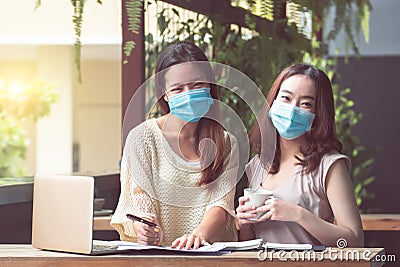 Women wearing mask and working from home Stock Photo