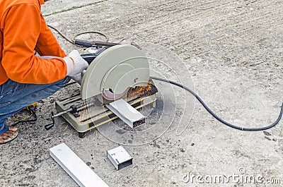 asian worker with machine cutting metal and welded steel to create a roof, local labor construction concept Stock Photo