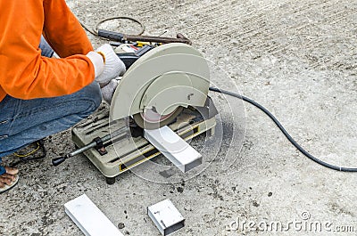 asian worker with machine cutting metal and welded steel to create a roof, local labor construction concept Stock Photo