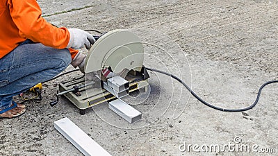 asian worker with machine cutting metal and welded steel to create a roof, local labor construction concept Stock Photo