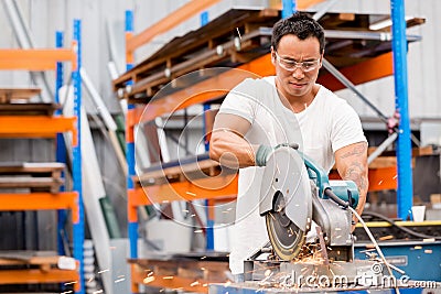 Asian worker in production plant on the factory floor Stock Photo