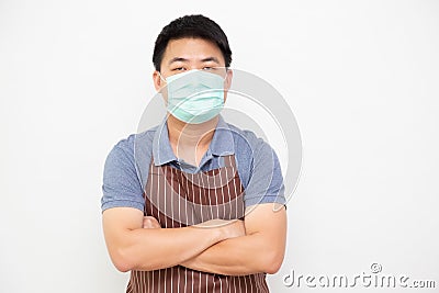 Asian workers fresh market with brown apron wearing protective medical mask for prevent virus. Stock Photo