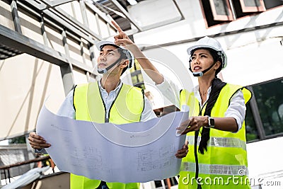 Asian workers people walking and checking onsite of architecture building straucture and work progress. Male and female engineers Stock Photo